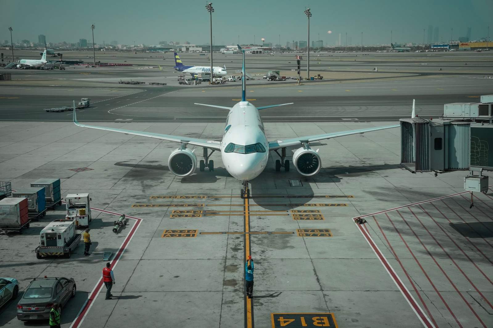 A jet parked at the gate on the apron of King Abdulaziz International Airport